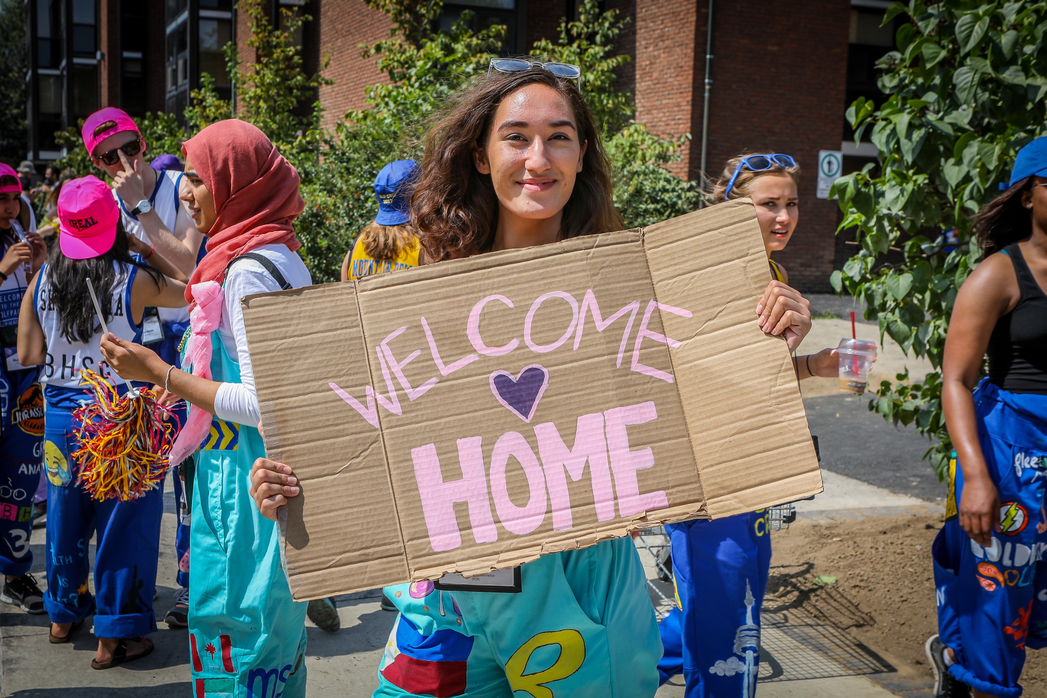Move-in Day Girl with Welcome Sign