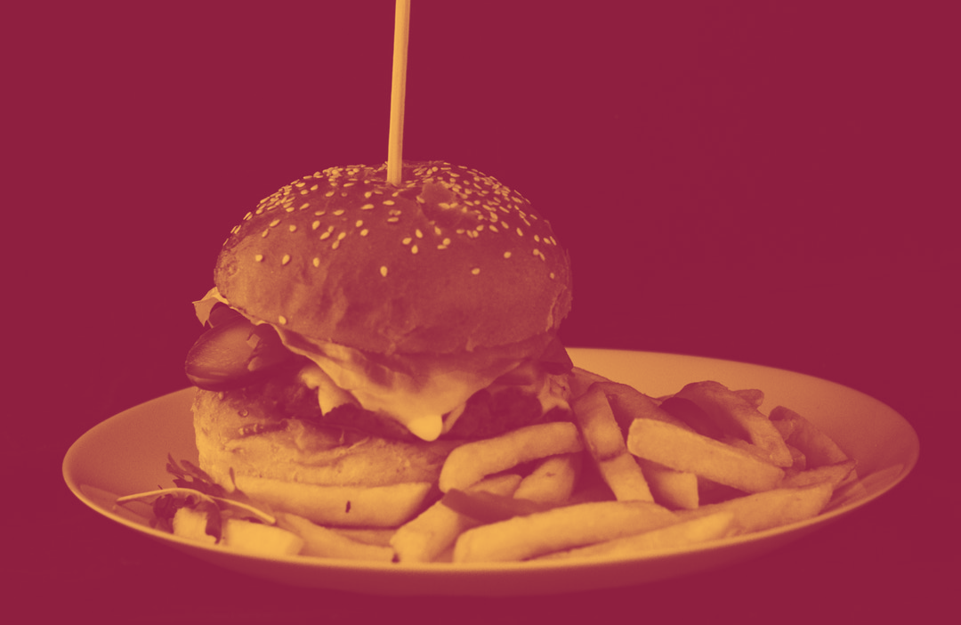 Hamburger on plate in red duotone